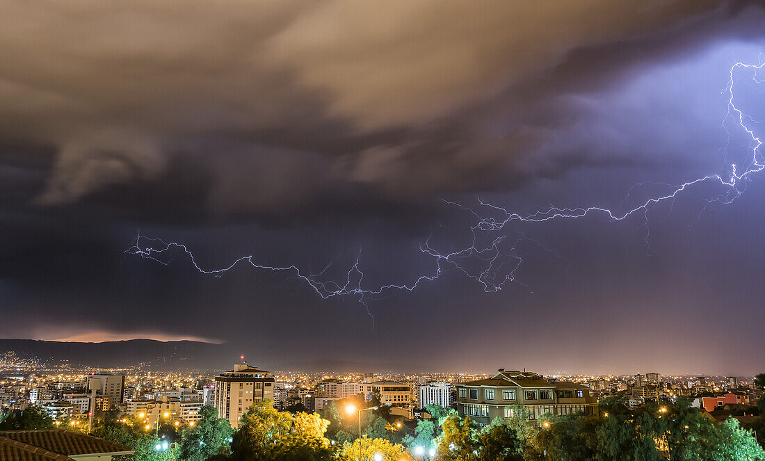 Stormy skies and lightning over a city at night; Cochabamba, Bolivia