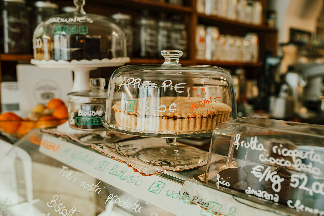 Display of confectioneries behind glass at a bakery; Italy