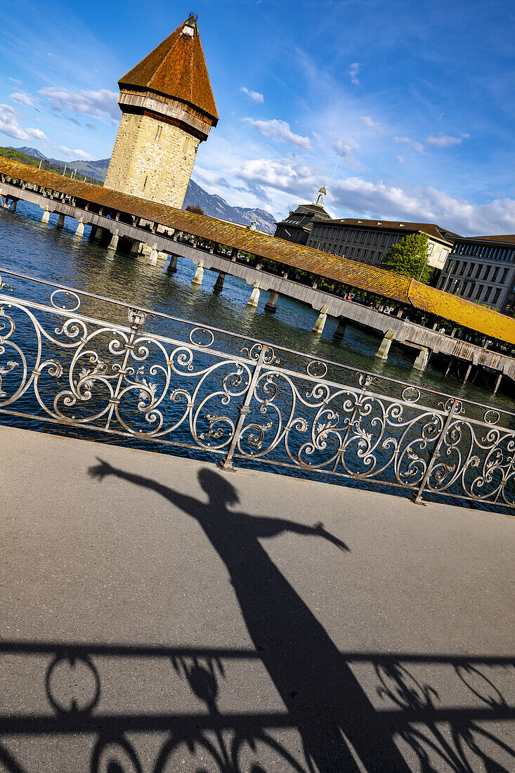 Chapel bridge over the River Reuss and shadow of tourist; Lucerne, Lucerne, Switzerland