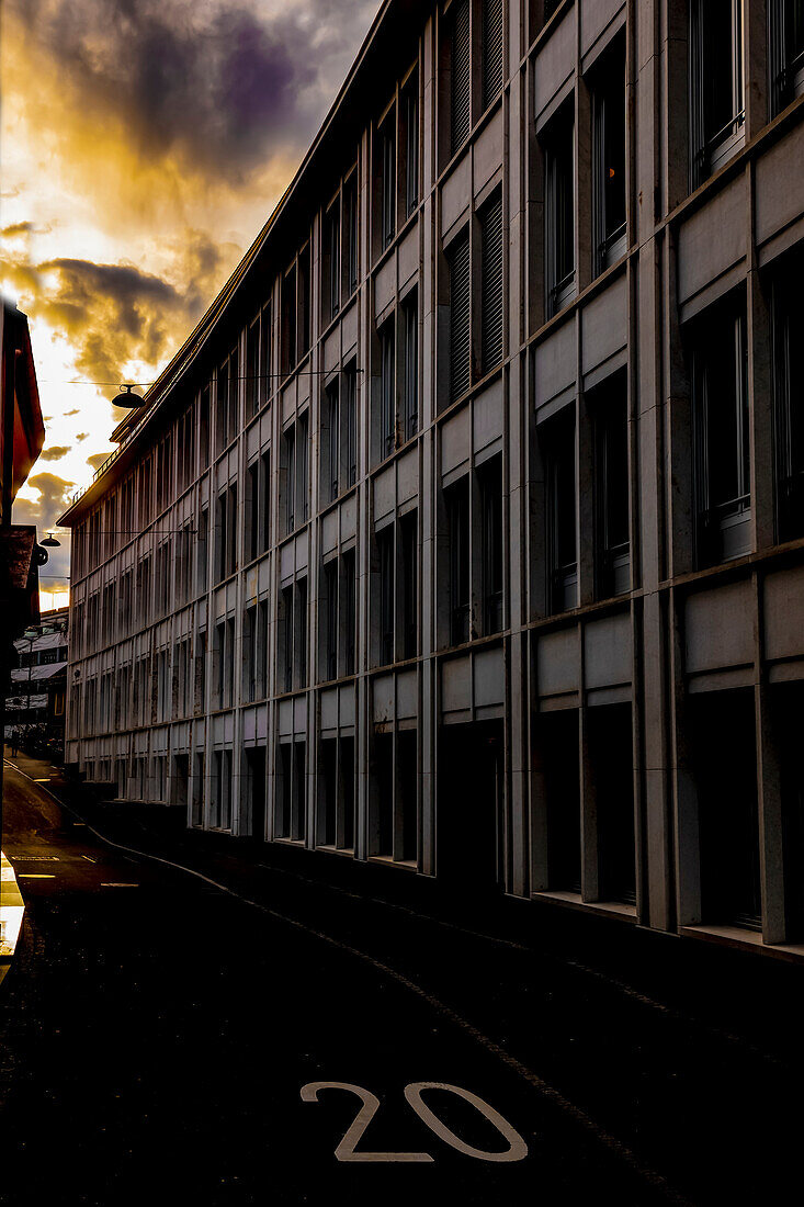 Building with the number twenty painted on the street at sunset; St. Gallen, St. Gallen, Swizterland