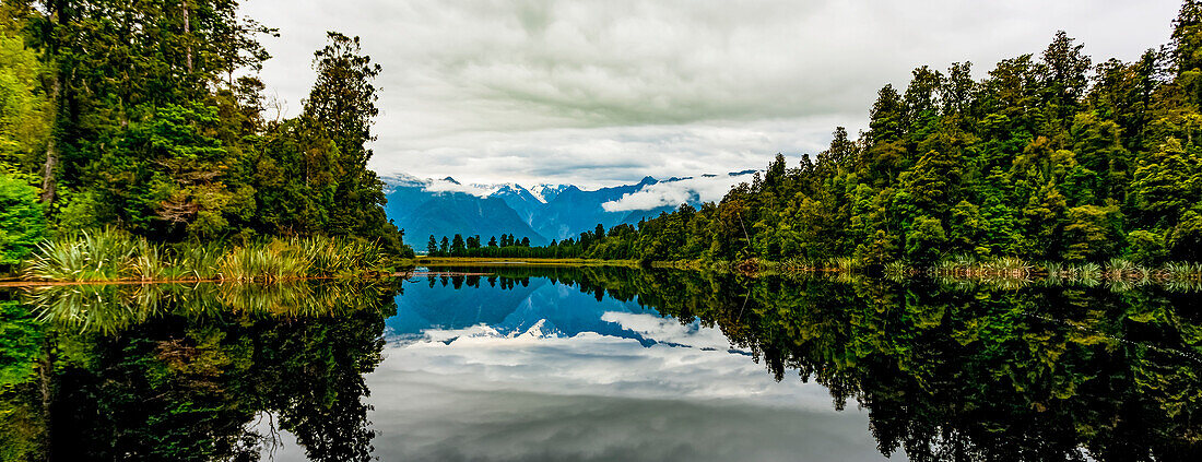 Mirror image of landscape into Lake Matheson; South Island, New Zealand