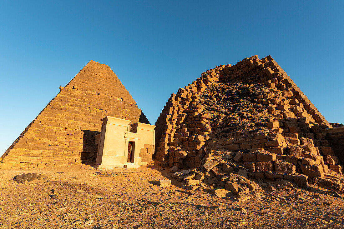Pyramids and reconstructed chapel in the Northern Cemetery at Begarawiyah, containing 41 royal pyramids of the monarchs who ruled the Kingdom of Kush between 250 BCE and 320 CE; Meroe, Northern State, Sudan