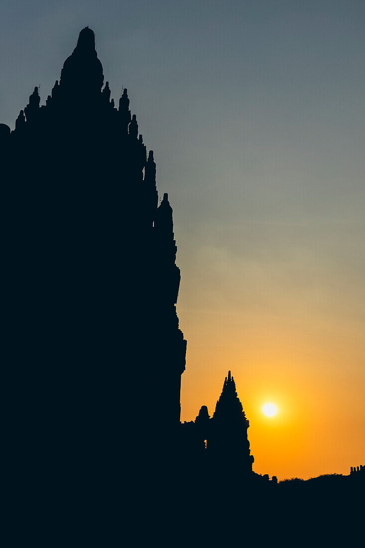 Sunset at Prambanan Temple with silhouetted peaks; Yogyakarta, Indonesia