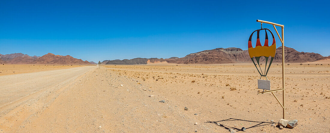 Driving on a long dry road, Namib Desert; Namibia