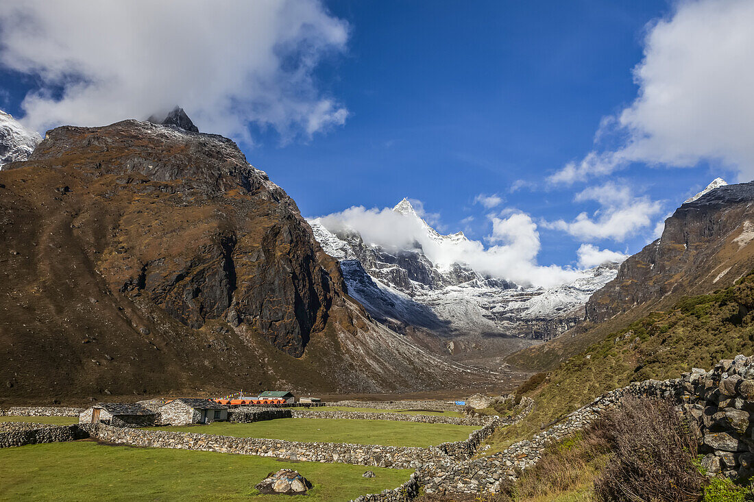 Farm fields divided by stone walls in a valley of the Himalayas; Nepal