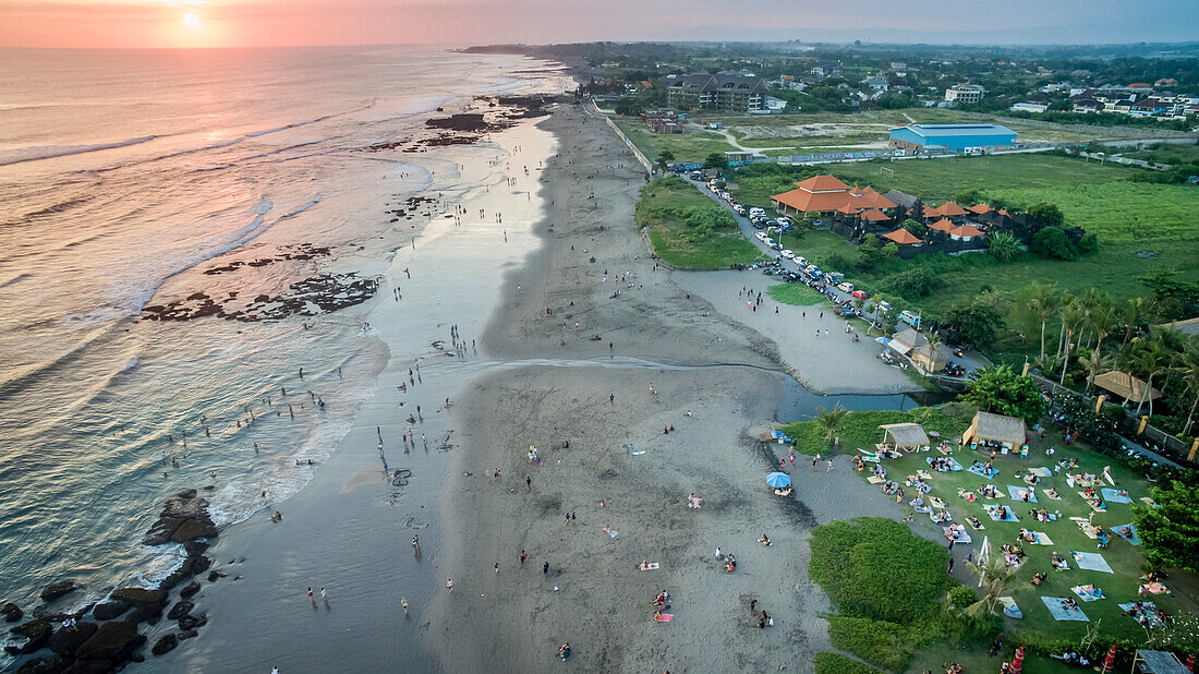 Crowds head to the beach in Canggu to catch a Bali sunset. Bean Bags complete the relaxing atmosphere; North Kuta, Bali, Indonesia
