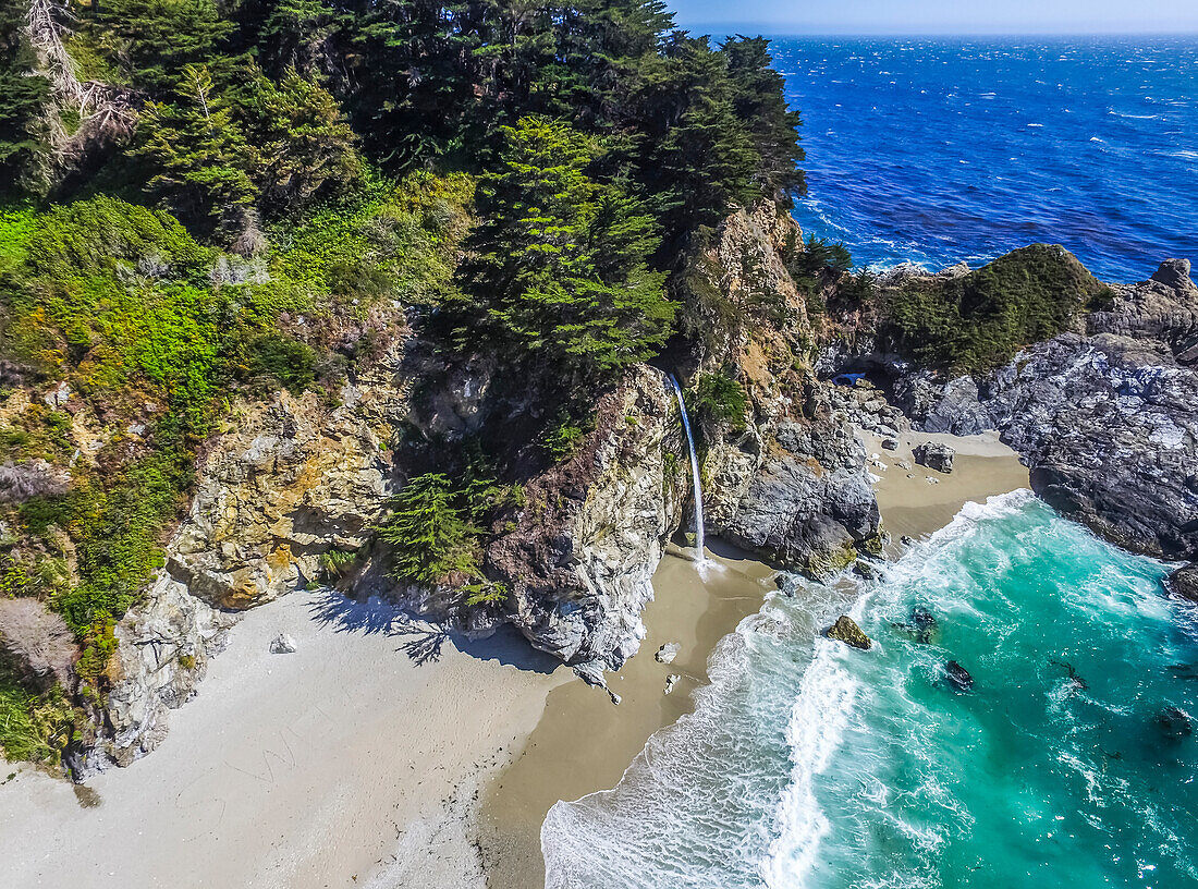 The McWay Falls waterfall falls onto the beach in Big Sur's Julia Pfeiffer Burns State Park; Big Sur, California, United States of America