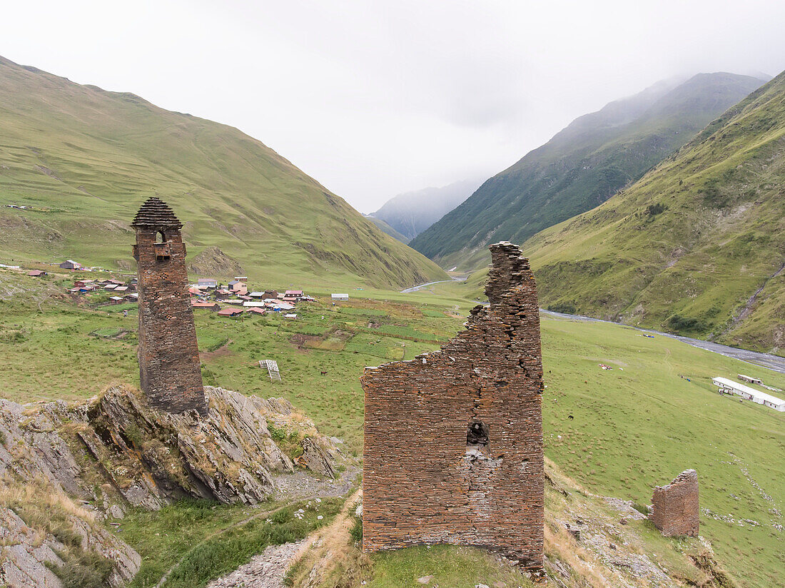 The ruins of the abandoned stone watch towers on the mountainside above the village of Girevi in the Tusheti National Park; Girevi, Kakheti, Georgia