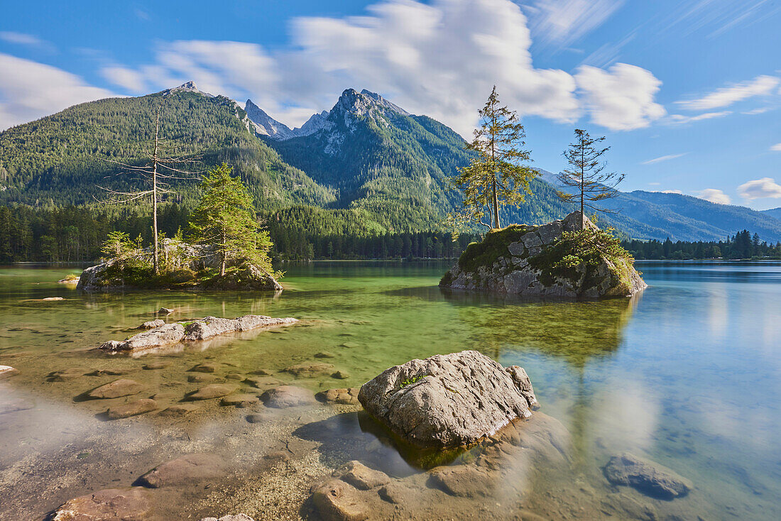 Norway spruce (Picea abies) trees on small, rock islands in the clear waters of Lake Hintersee, Bavarian Alps; Berchtesgadener Land, Ramsau, Bavaria, Germany