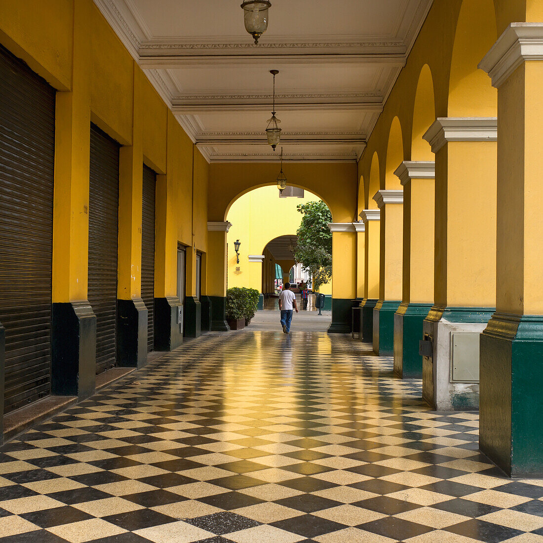 A Man Walks Down The Corridor In The Historic Centre Of Lima; Lima Peru