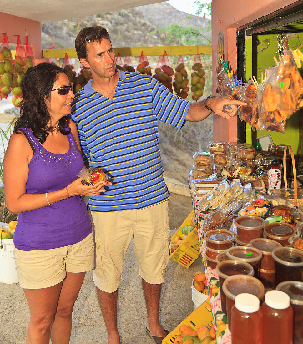A Couple Looks At A Roadside Fruit Stand Near Los Cabos Area; San Jose Del Cabo Baja California Sur Mexico
