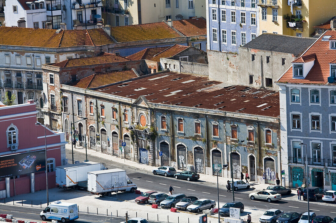 Weathered Old Buildings Along A Road With Parked Cars; Lisbon, Portugal