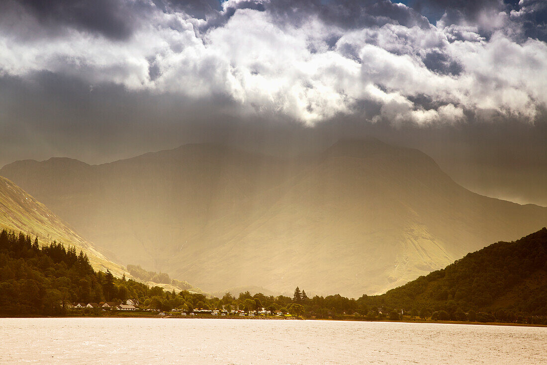 Sunlight Shining Through The Clouds Into A Glowing Valley; Argyll Scotland