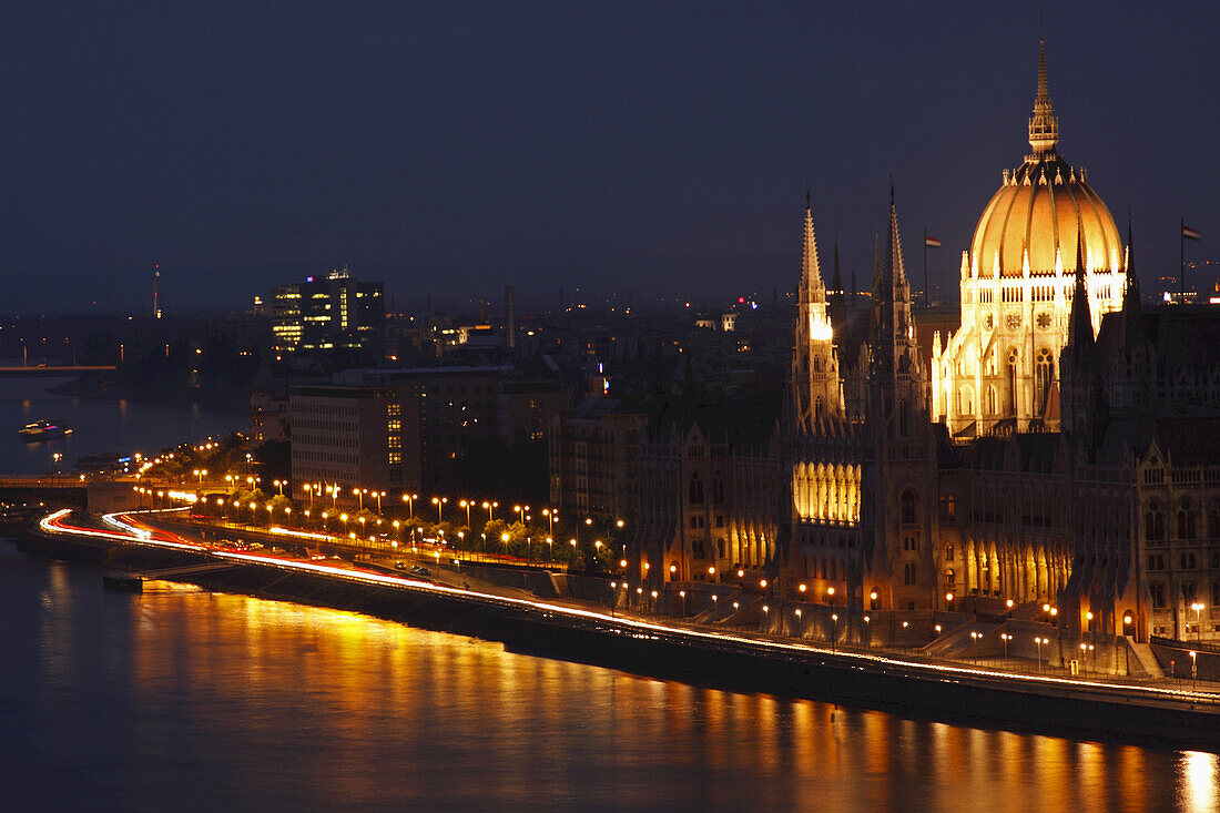 Night Lights Of Parliament Building Beside The Danube River; Budapest Hungary