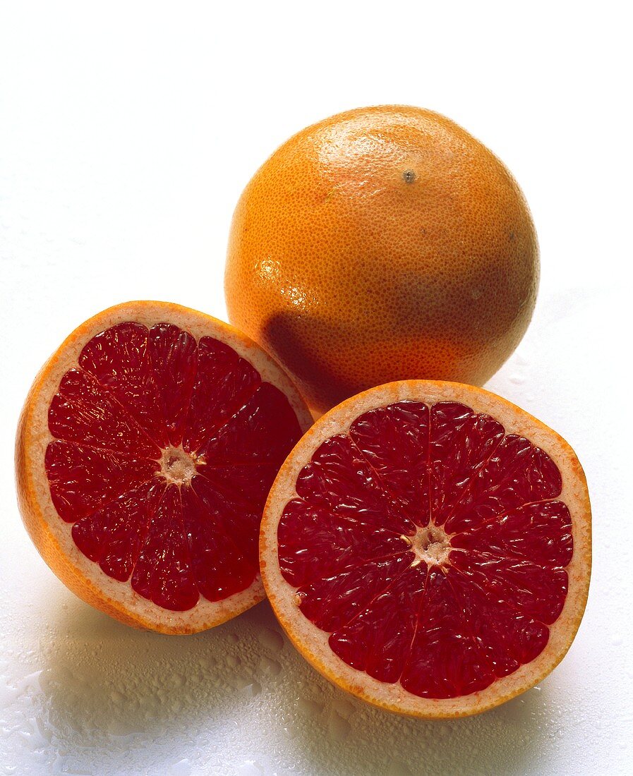 Whole and Halved Pink Grapefruit