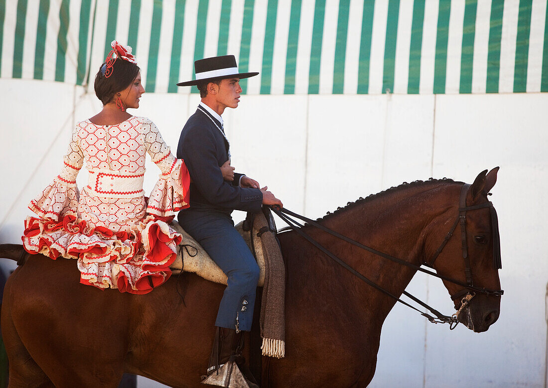 A Young Man And Woman Ride On A Horse In Feria; Tarifa Cadiz Andalusia Spain