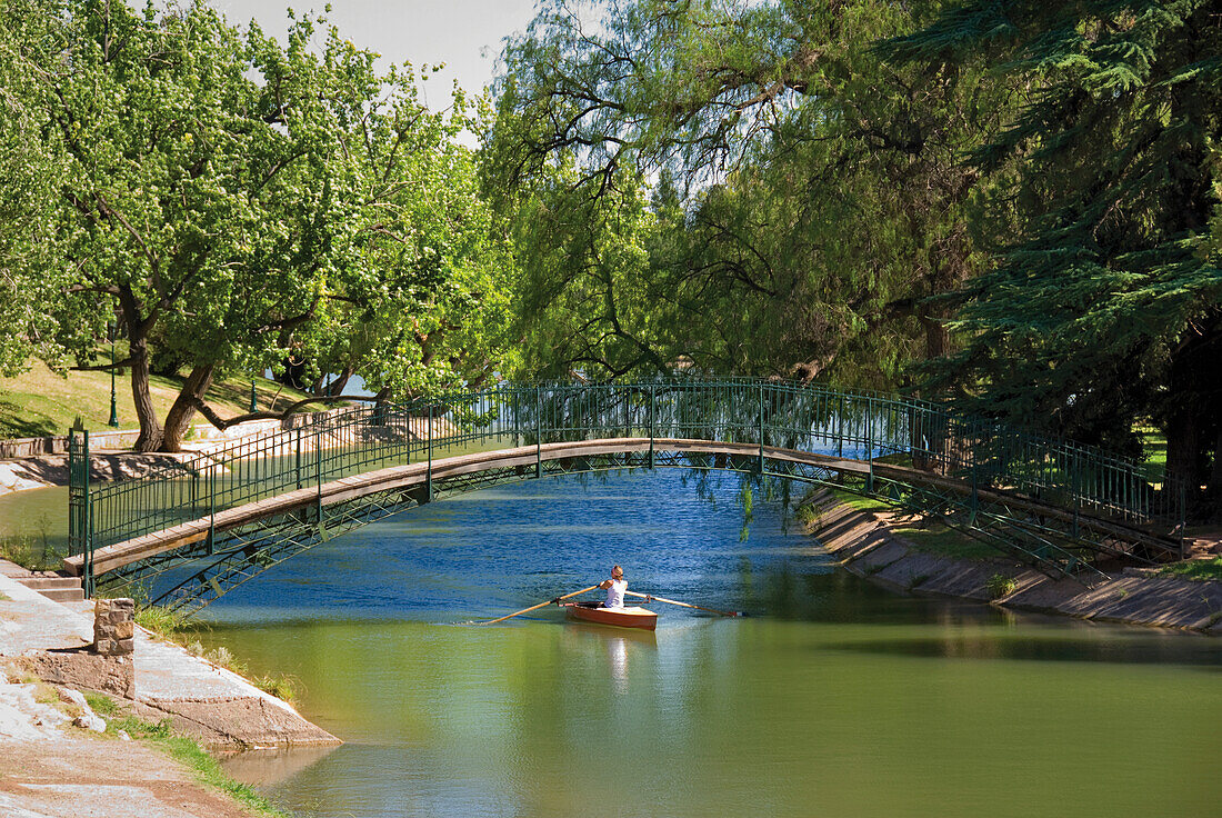 Red Kayak Under A Footbridge In A City Park; Mendoza Argentina