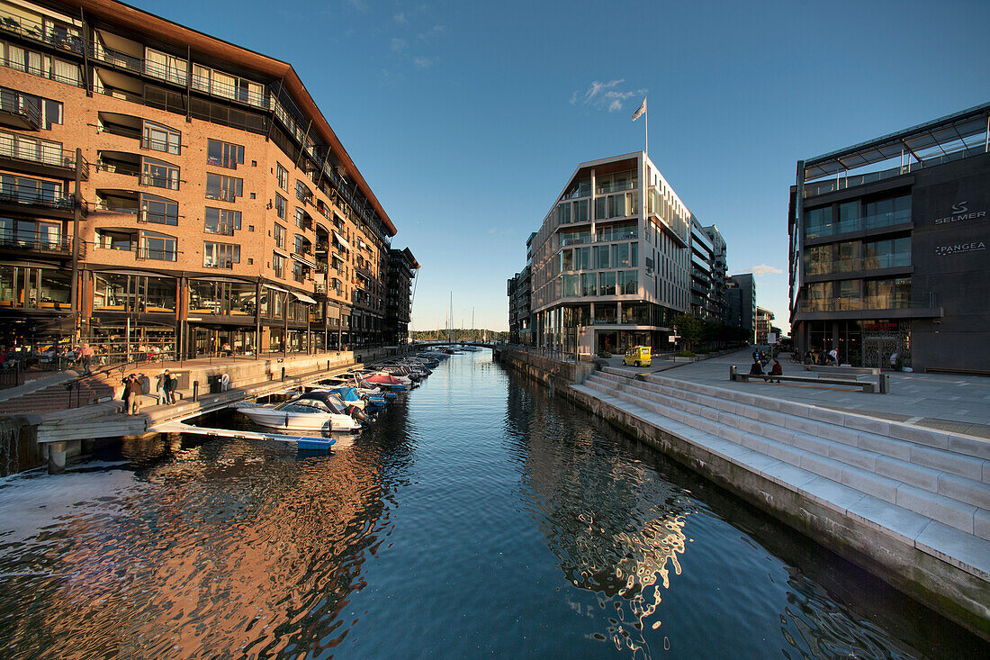 Boats Moored In A Canal With Residential Buildings; Oslo Norway