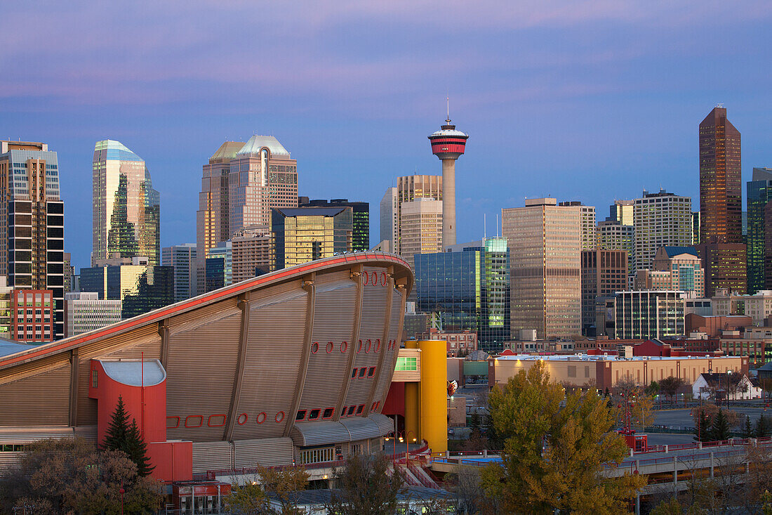 Calgary Skyline With The Saddledome Calgary Tower And Buildings At Dawn With Deep Blue Sky And Magenta Clouds; Calgary Alberta Canada
