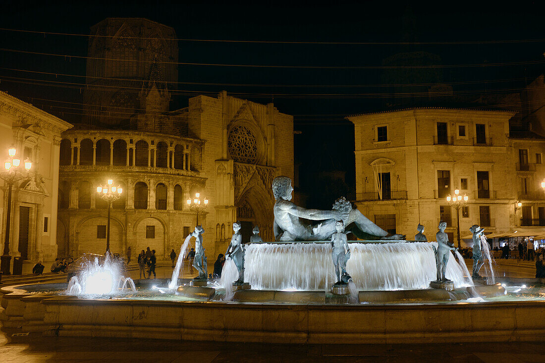 Illuminated Turia Fountain at Night with Valencia Cathedral in background lett, Plaza de la Virgen, Valencia, Spain