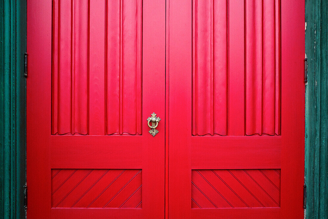 Red Wood Doors with Ornate Metal Handle