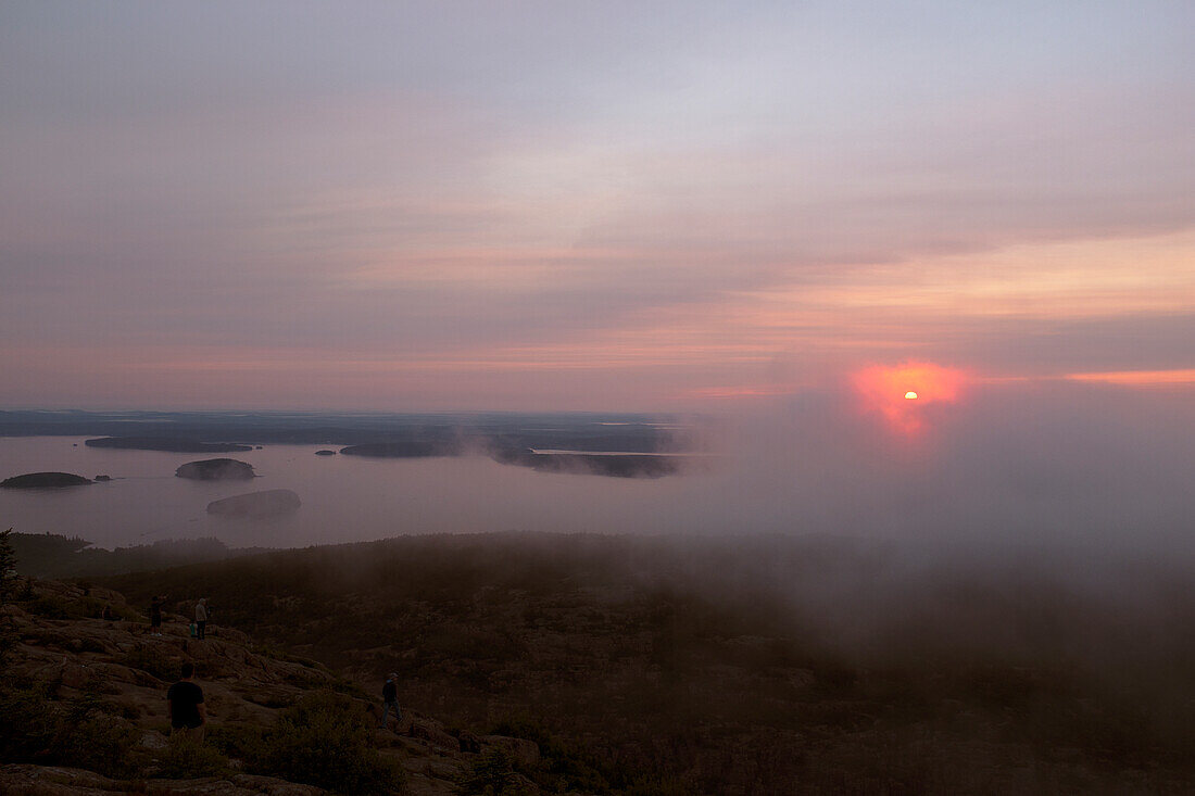 Group of People gathered to watch Sunrise viewed from Cadillac Mountain, Maine, USA