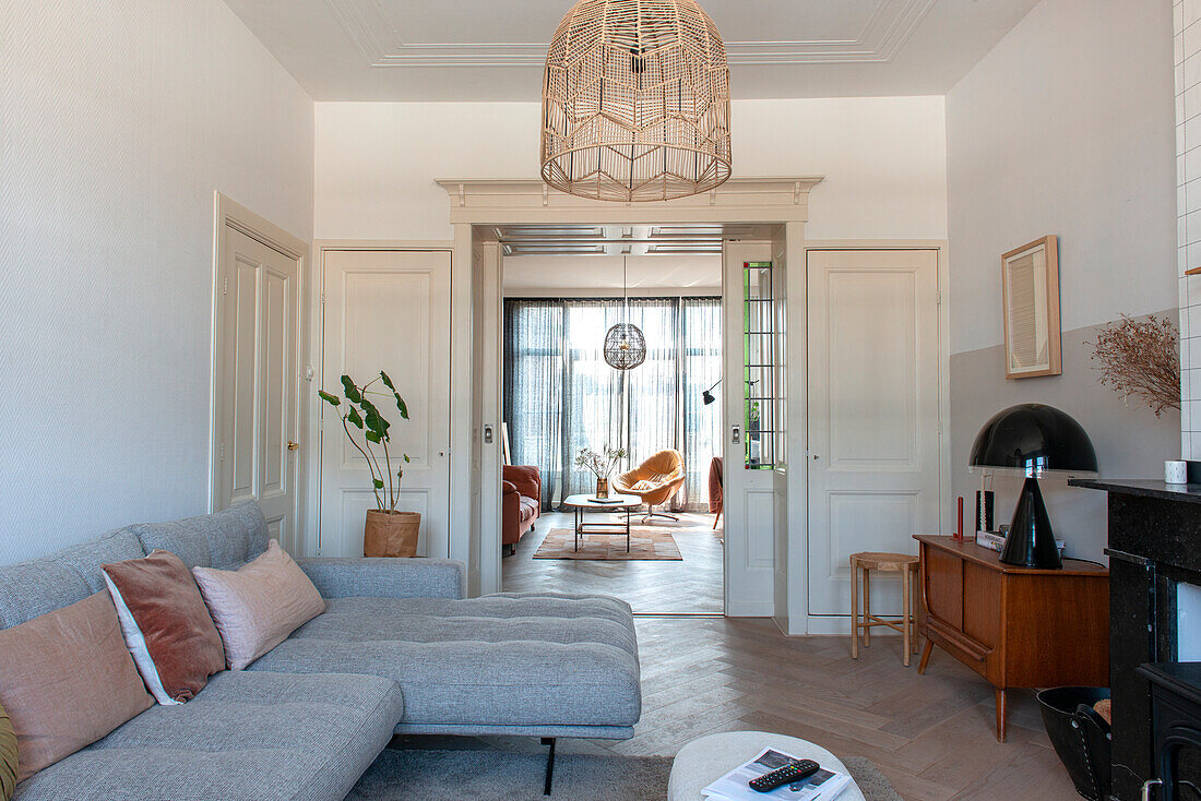 Grey upholstered sofa and retro cupboard in the living room