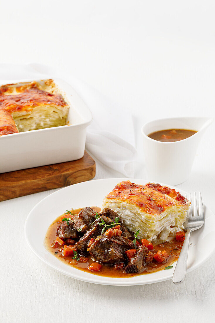 Braised beef cheek with vegetables served with potato gratin