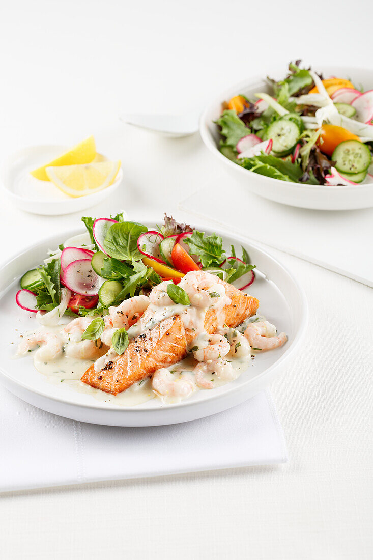 Salmon and shrimp in white sauce, with side salad