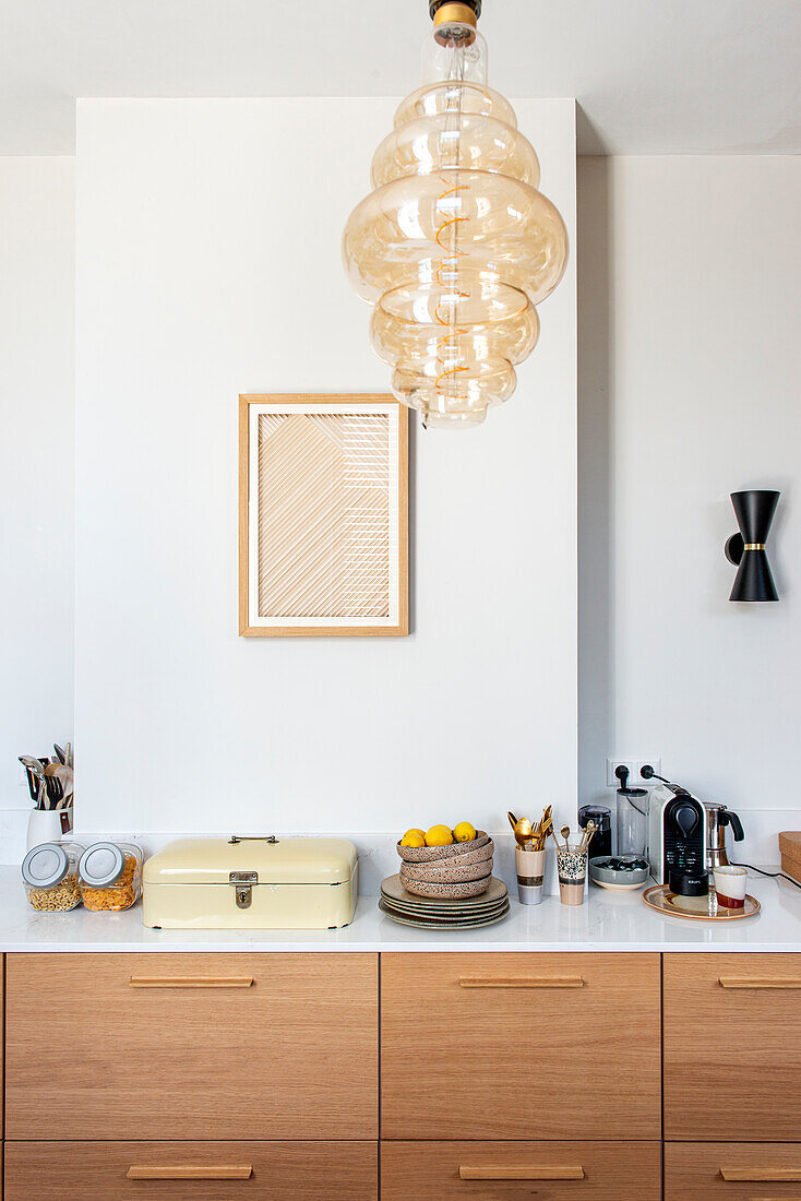 Modern kitchen in light-colored wood with white worktop