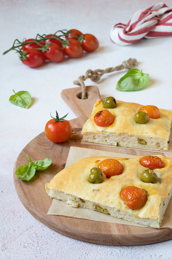 Focaccia with cherry tomatoes, olives and aromatic herbs