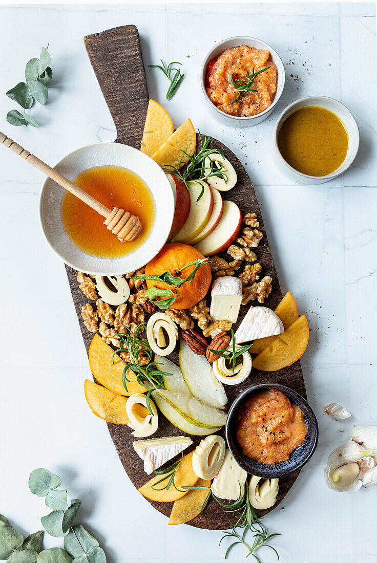 Cheese with honey, persimmon, mandarin oranges, nuts, tomato chutney, and pears