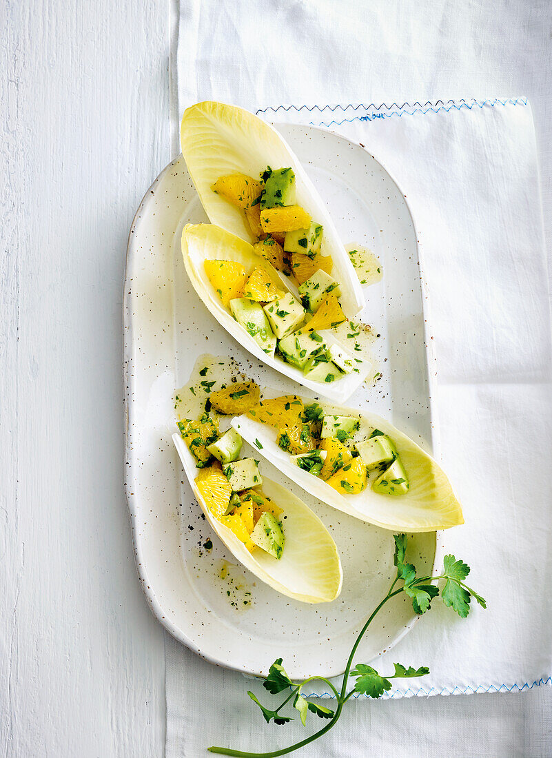 Chicory boat with avocado and orange