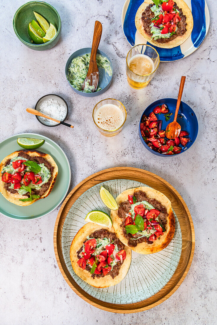 Smash tortillas with ground lamb, tzatziki and tomato salad