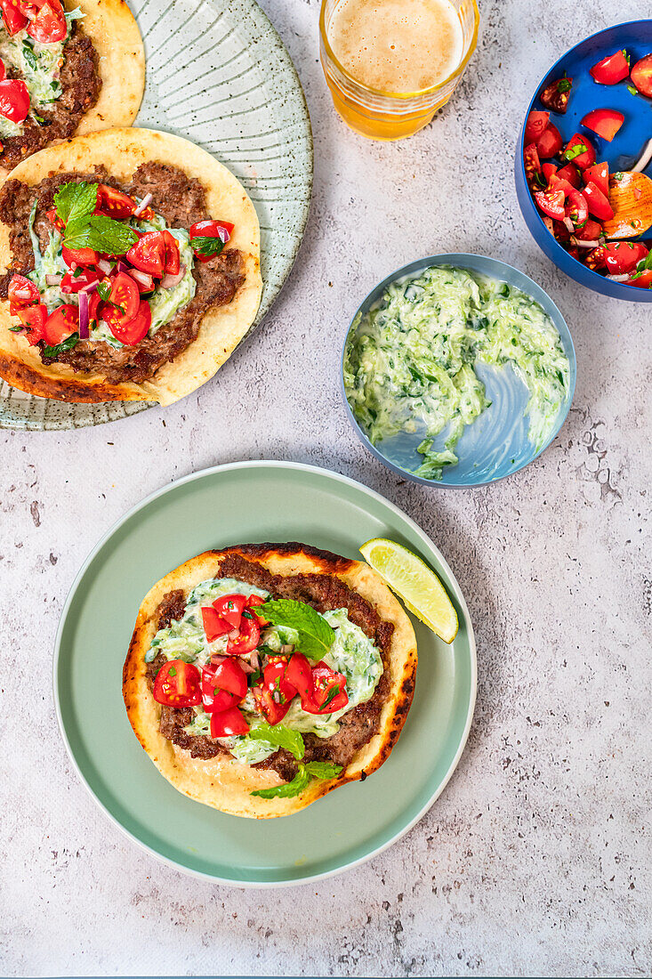 Smash tortillas with lamb burger, tzatziki and tomato salad