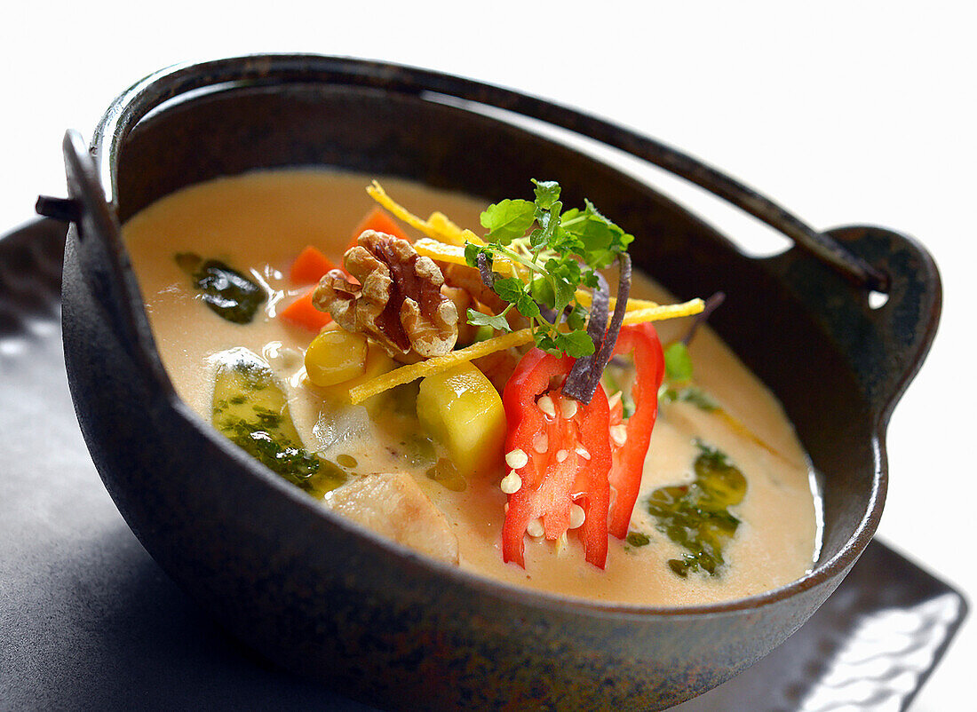 Thai chicken soup with chili and nuts