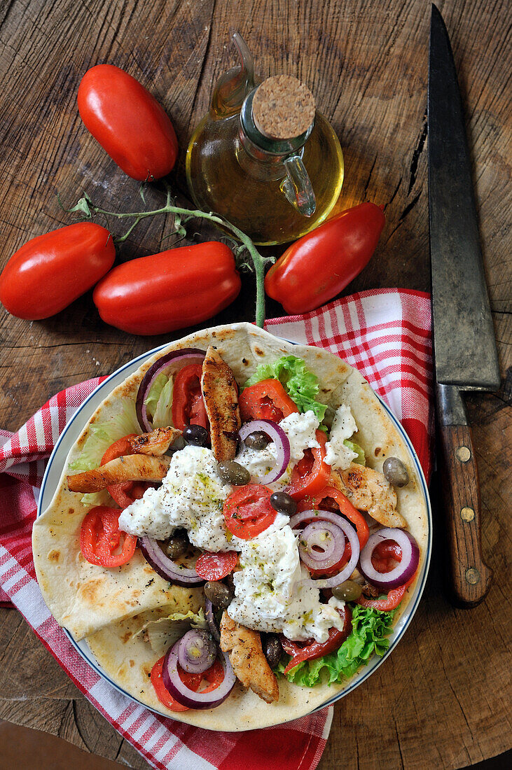 Piadina with chicken, mozzarella, olives and tomatoes
