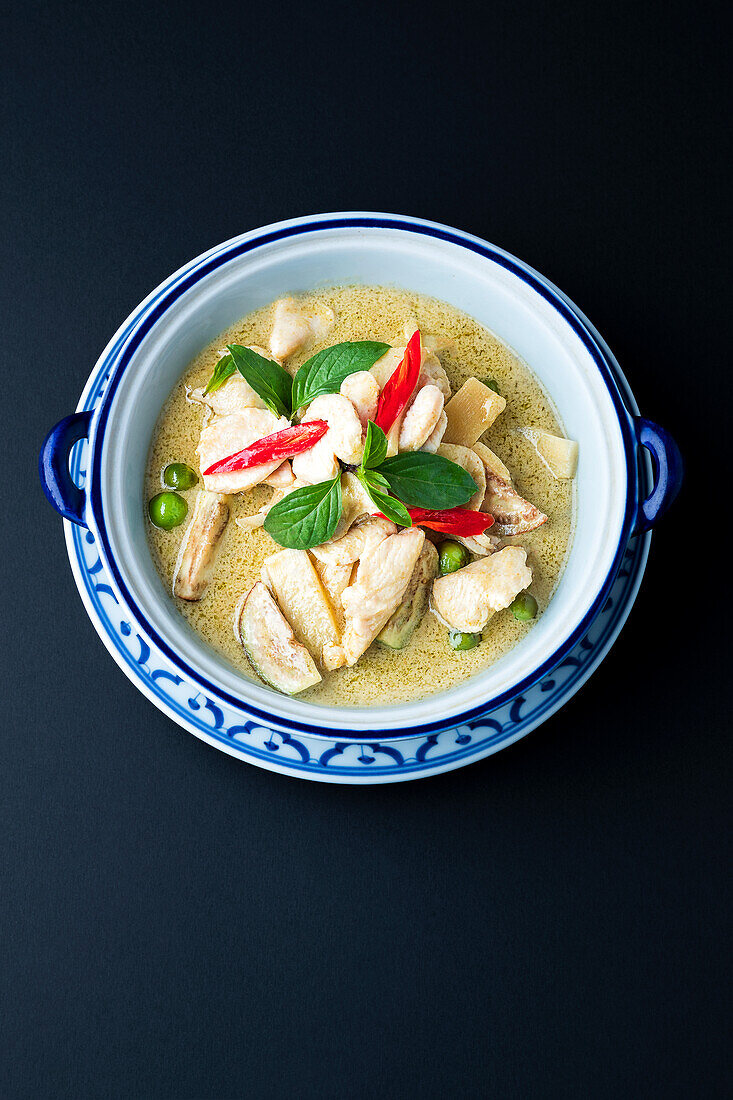 Chicken with green curry sauce, chili and Thai basil