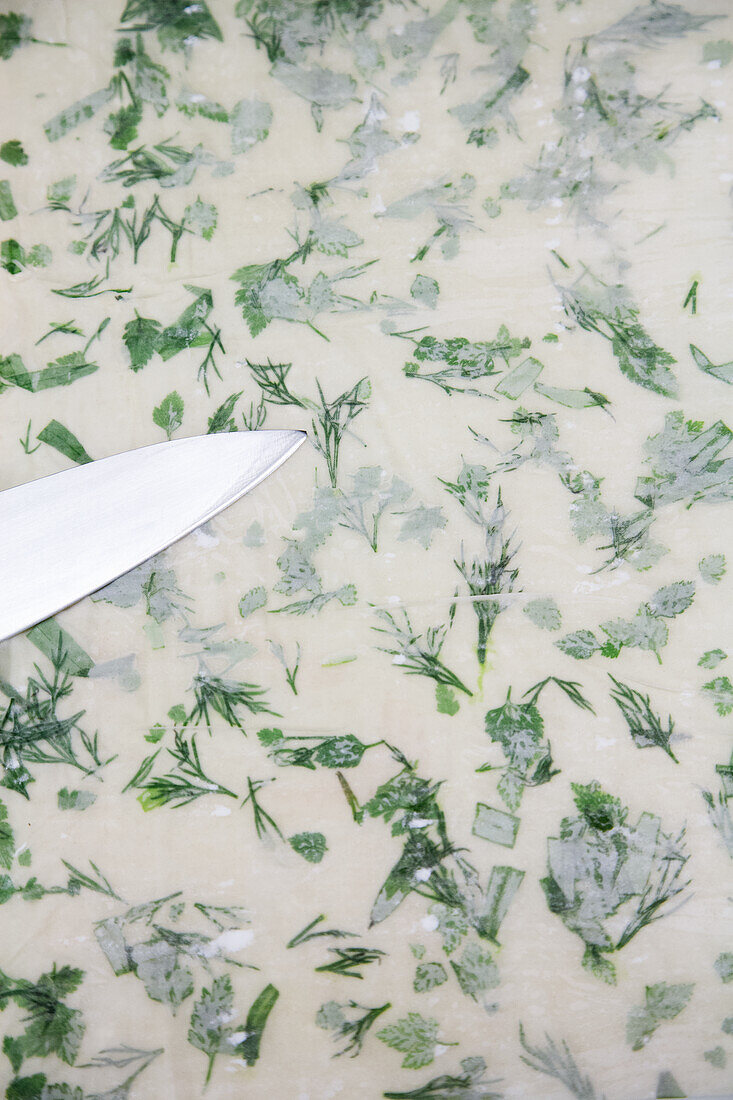Thin bread dough with herbs; uncooked