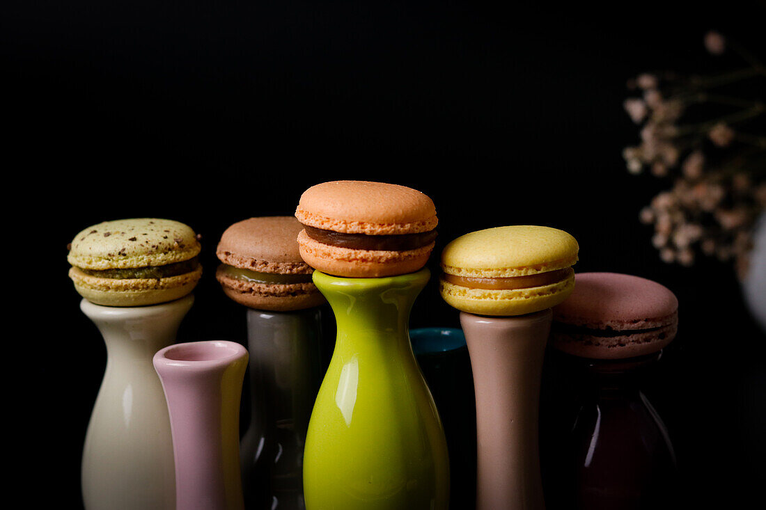 Macarons on colourful ceramic vases