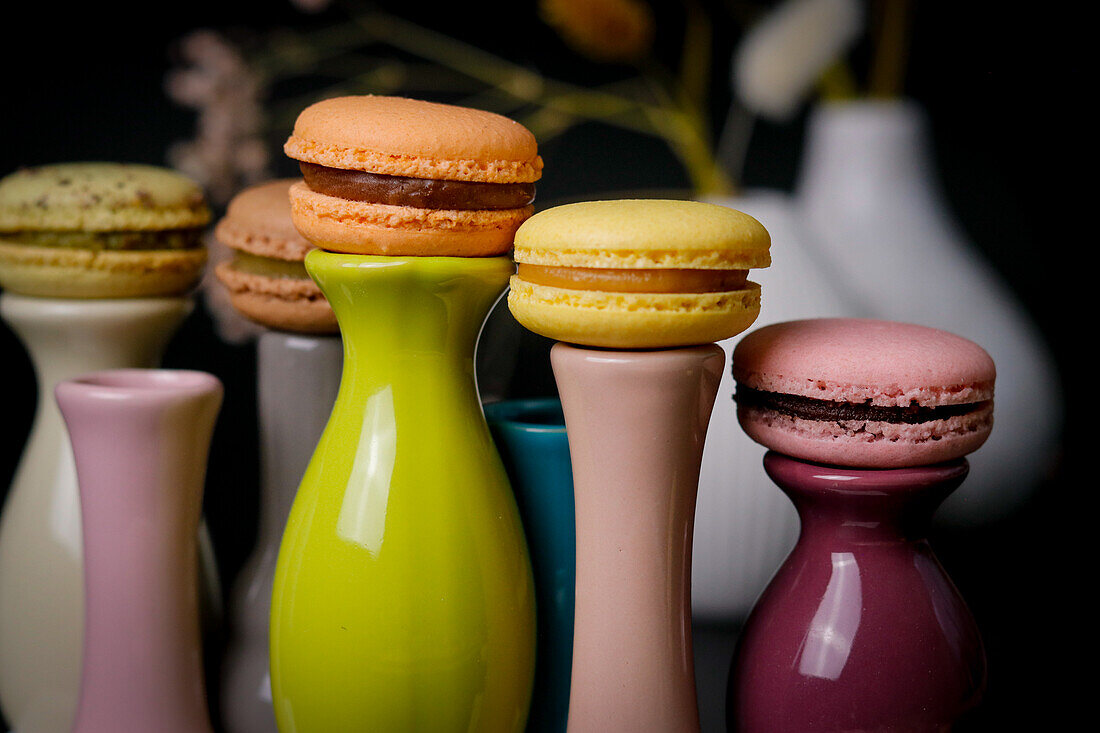 Macarons on colourful ceramic vases