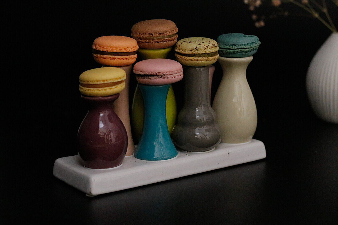 Macarons on colourful ceramic vases