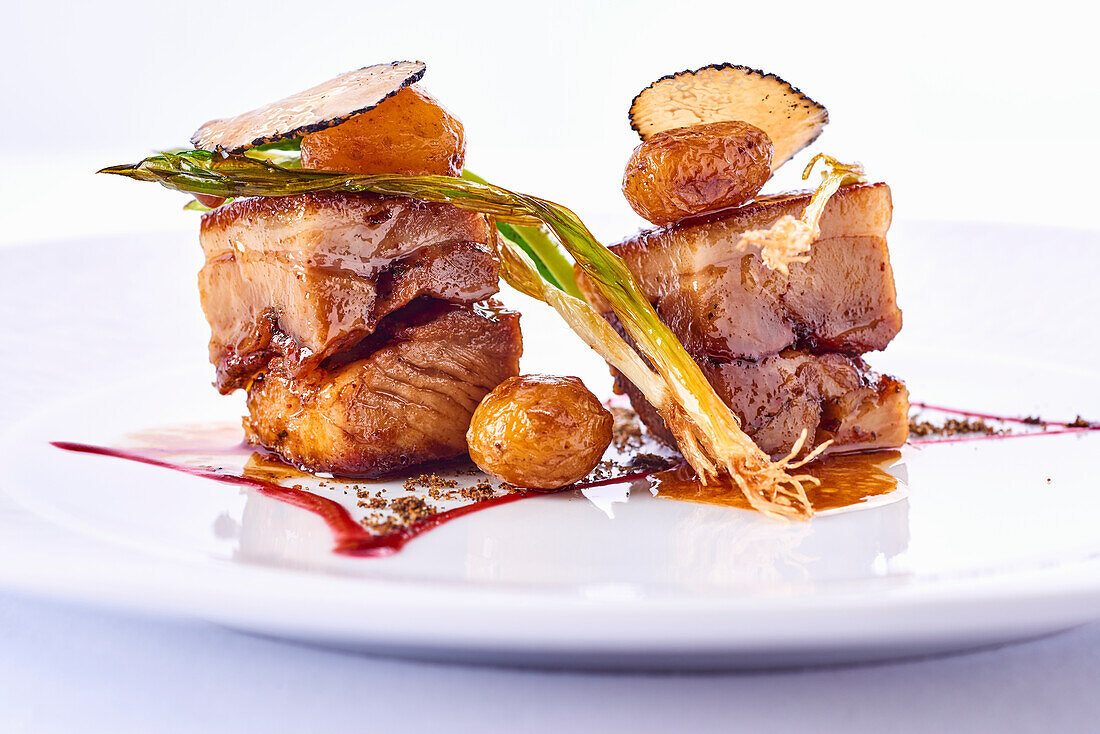 Pig with small potatoes and truffle