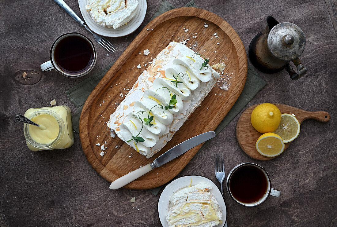 Meringue roll with lemon curd, cream cheese, and almonds