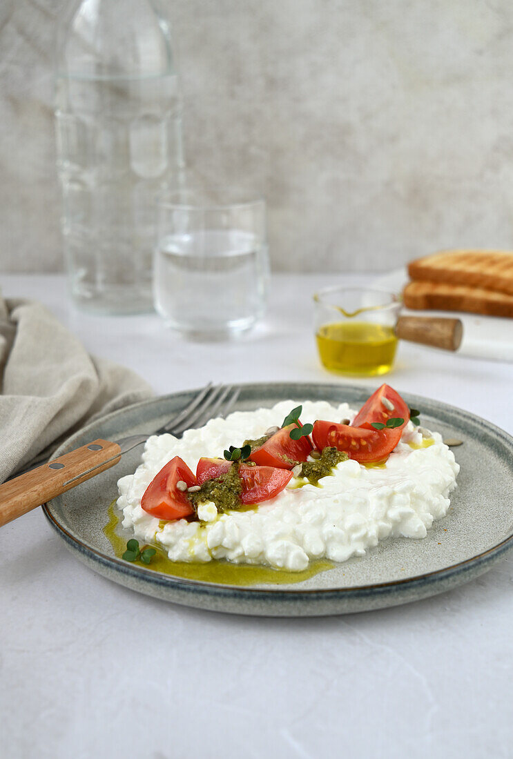 Cottage cheese with cherry tomatoes and pesto