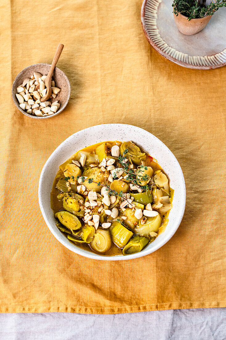 Poached leeks in white wine with garlic, thyme and almonds