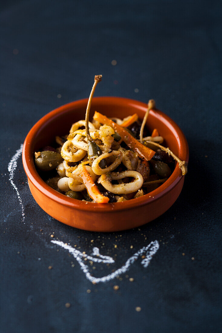 Tapas with squid rings, capers, and peppers