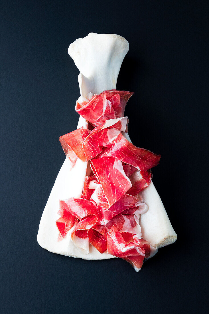Iberico ham in thin slices on pork bones