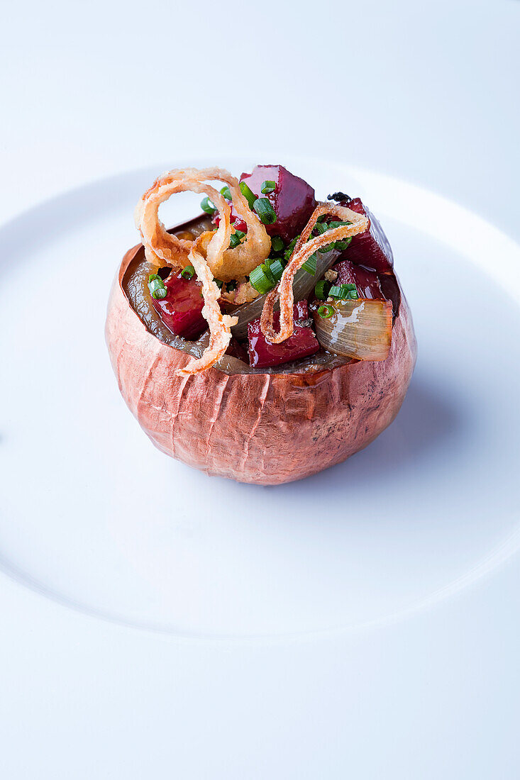 Braised stuffed onion with beetroot, herbs and onion tempura