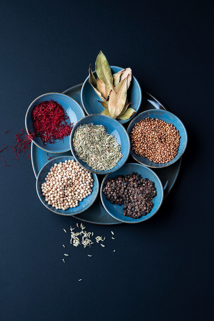 Various spices in blue bowls